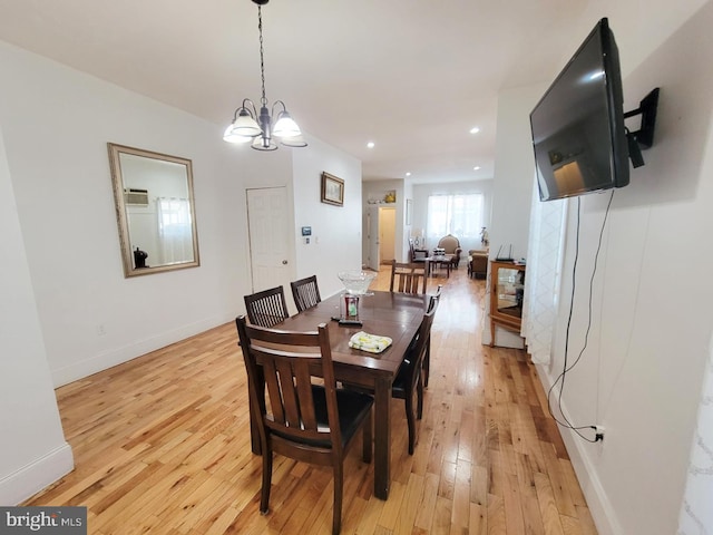 dining space featuring recessed lighting, light wood-type flooring, baseboards, and a notable chandelier