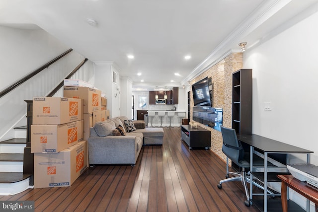 living area featuring stairway, visible vents, recessed lighting, hardwood / wood-style flooring, and crown molding