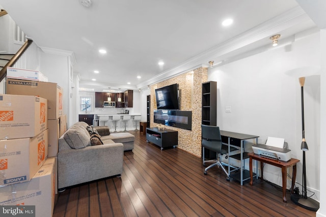 living area with recessed lighting, crown molding, and dark wood-style flooring