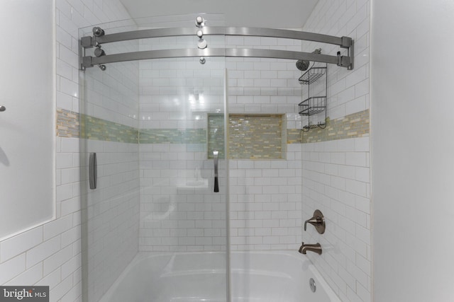 bathroom with shower / bath combination with glass door