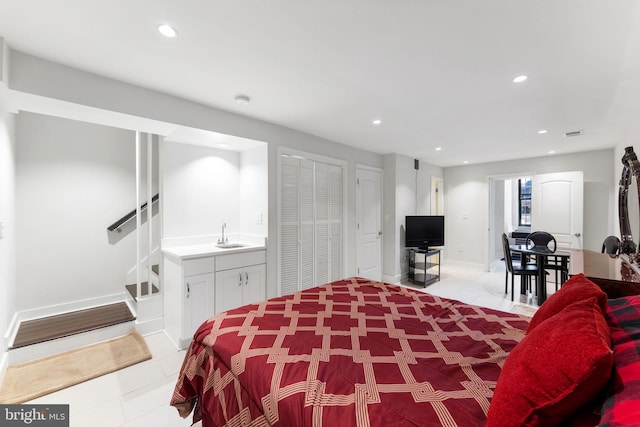 bedroom featuring indoor wet bar, recessed lighting, baseboards, and a sink