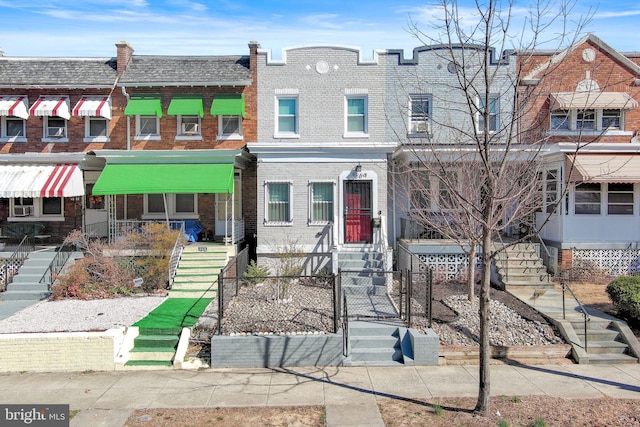 townhome / multi-family property featuring brick siding