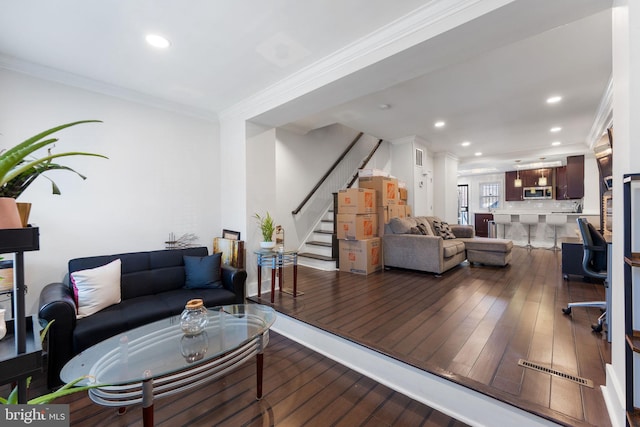 living area featuring hardwood / wood-style floors, crown molding, stairs, and recessed lighting