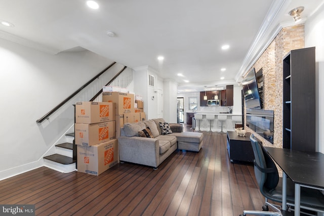 living area with stairway, dark wood-type flooring, and crown molding