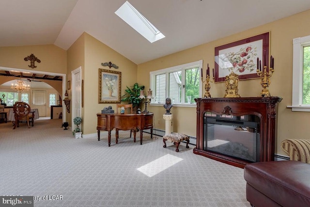 sitting room with carpet, lofted ceiling with skylight, arched walkways, a glass covered fireplace, and a baseboard radiator