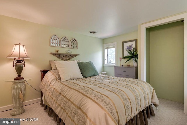 carpeted bedroom featuring baseboards and visible vents