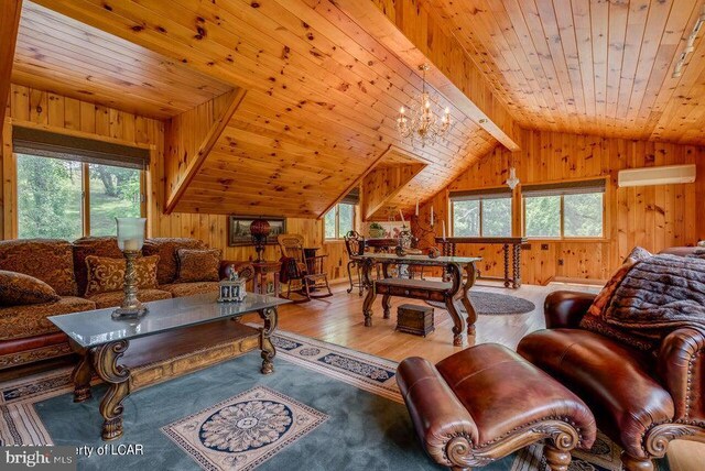 living room with wood ceiling, wooden walls, and a healthy amount of sunlight