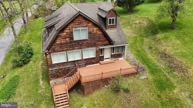 back of house with a shingled roof and a wooden deck