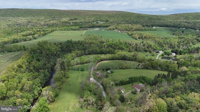 drone / aerial view featuring a rural view and a wooded view