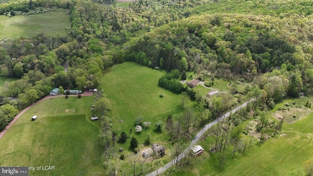 bird's eye view featuring a wooded view