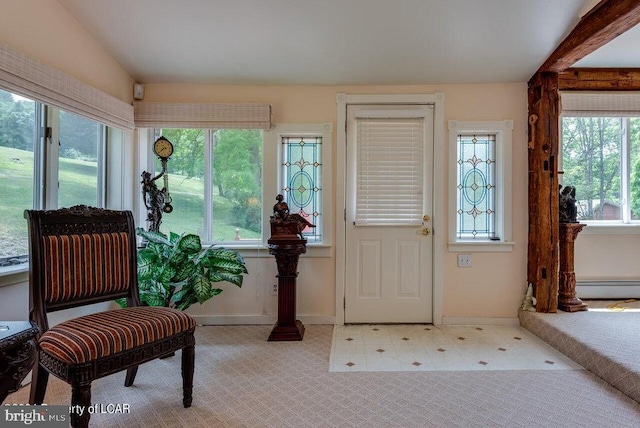 foyer featuring lofted ceiling, baseboards, and tile patterned floors