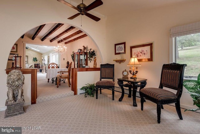 living area featuring arched walkways, ceiling fan with notable chandelier, vaulted ceiling with beams, and carpet