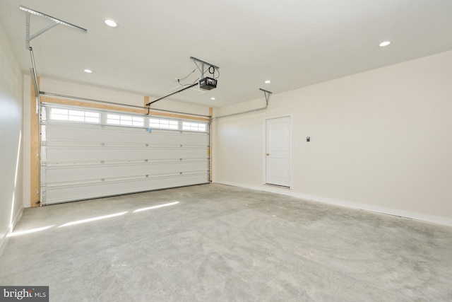 garage featuring recessed lighting, a garage door opener, and baseboards