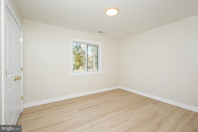 unfurnished bedroom with visible vents, light wood-style flooring, and baseboards