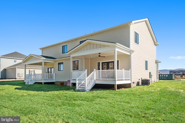 rear view of property featuring central air condition unit, a lawn, a ceiling fan, board and batten siding, and crawl space