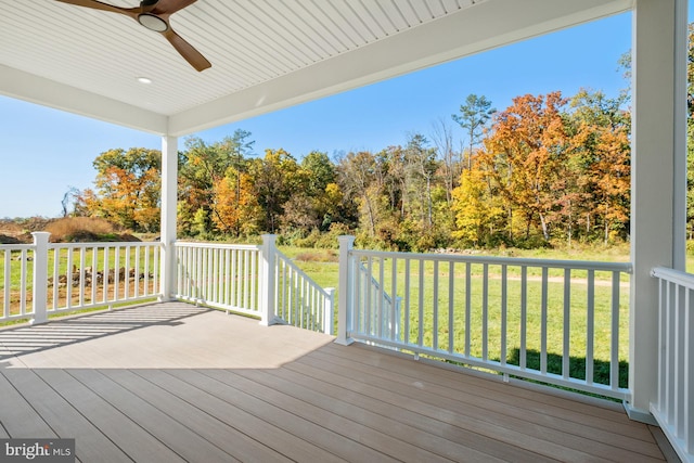 deck featuring a lawn and ceiling fan