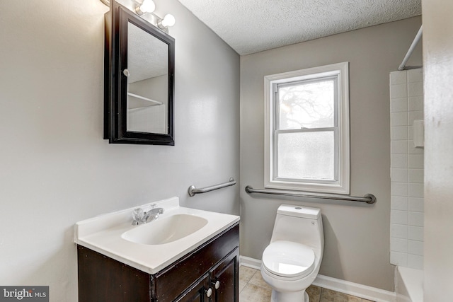 bathroom with vanity, baseboards, a textured ceiling, tile patterned floors, and toilet