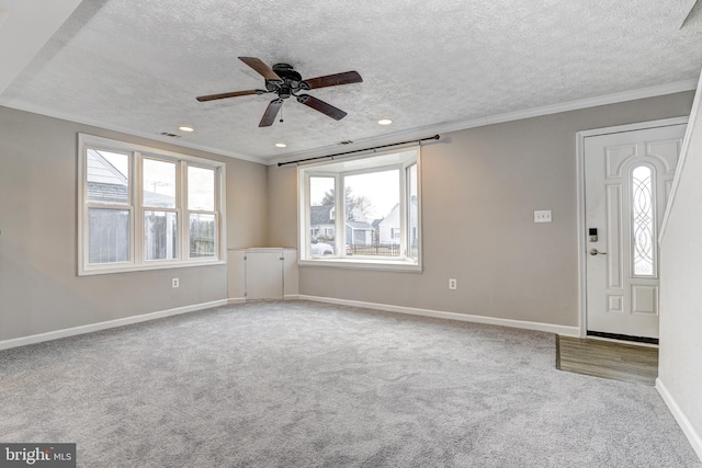 foyer entrance featuring carpet, baseboards, recessed lighting, a textured ceiling, and crown molding