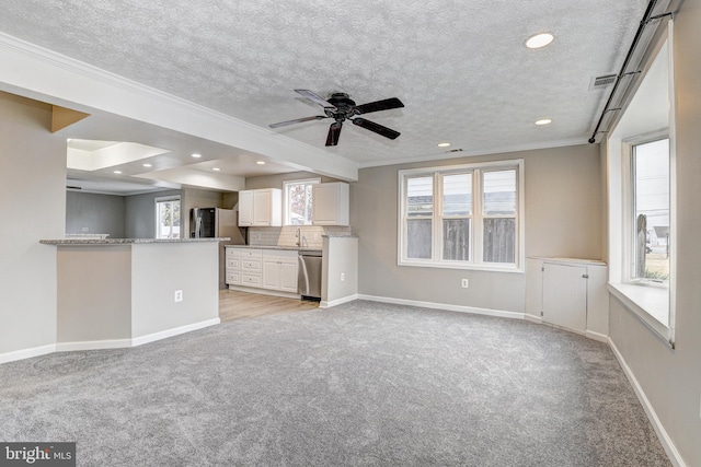 unfurnished living room with baseboards, recessed lighting, ornamental molding, a textured ceiling, and light colored carpet