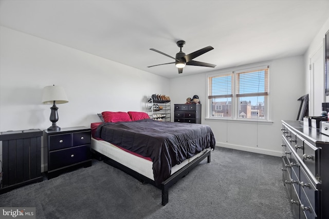 bedroom with a ceiling fan and dark carpet