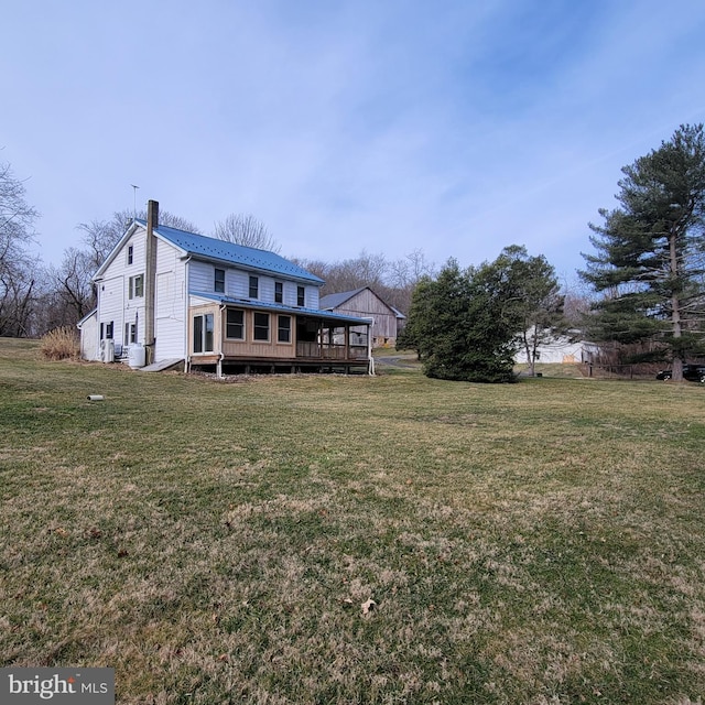 view of front facade with a wooden deck and a front lawn