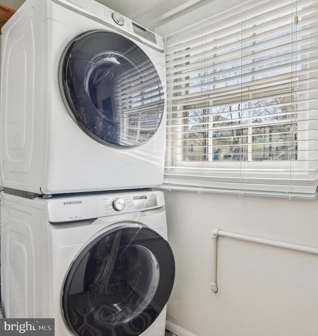 laundry room with laundry area and stacked washer / dryer