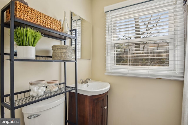 half bathroom featuring toilet and vanity