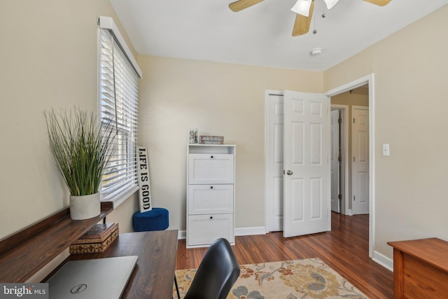 office space featuring baseboards, wood finished floors, and a ceiling fan