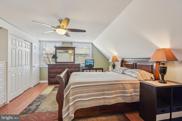 bedroom featuring vaulted ceiling, baseboards, light wood-type flooring, and ceiling fan