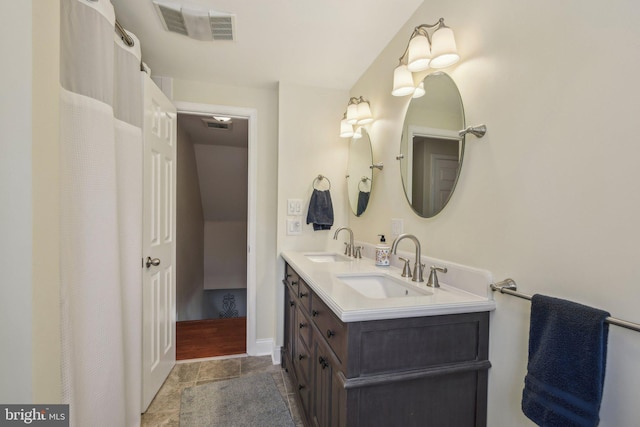 full bathroom with a sink, visible vents, and double vanity