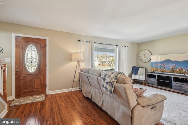 living area featuring baseboards and wood finished floors