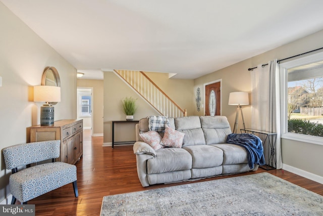 living room featuring stairway, baseboards, and dark wood-style floors