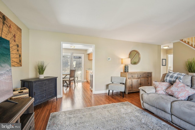 living area with wood finished floors and baseboards