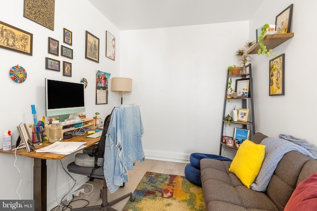 office space featuring baseboards and wood finished floors