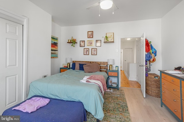 bedroom with light wood-type flooring and a ceiling fan