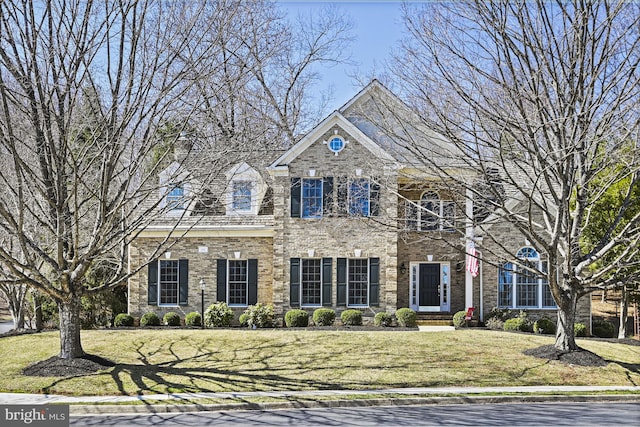 view of front of house with brick siding and a front yard