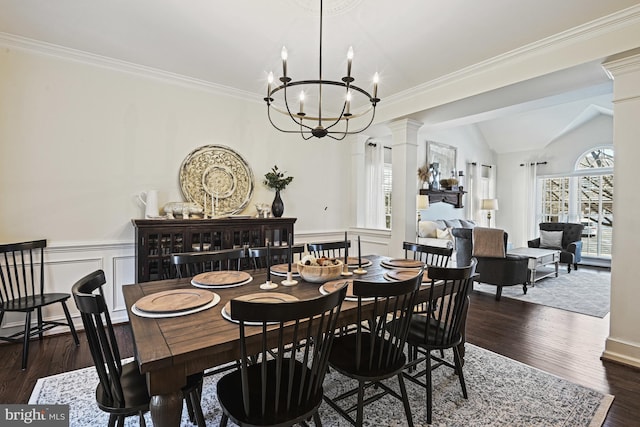 dining space with lofted ceiling, decorative columns, dark wood-style flooring, and wainscoting