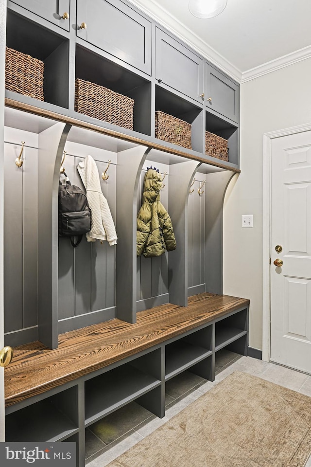 mudroom featuring tile patterned floors and ornamental molding