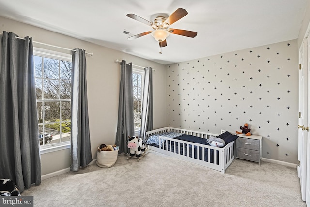 carpeted bedroom with baseboards, a ceiling fan, and wallpapered walls