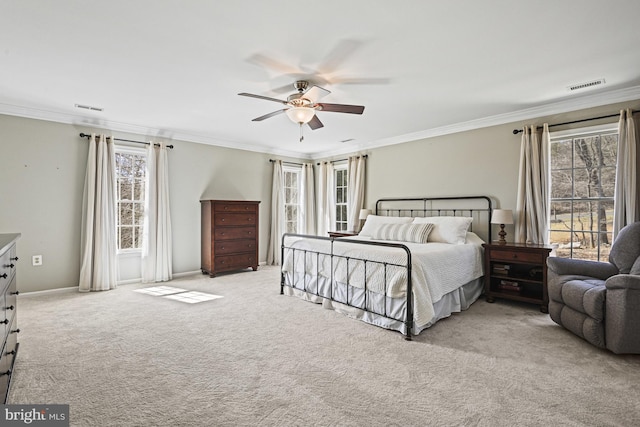 bedroom featuring visible vents, light colored carpet, ceiling fan, and ornamental molding