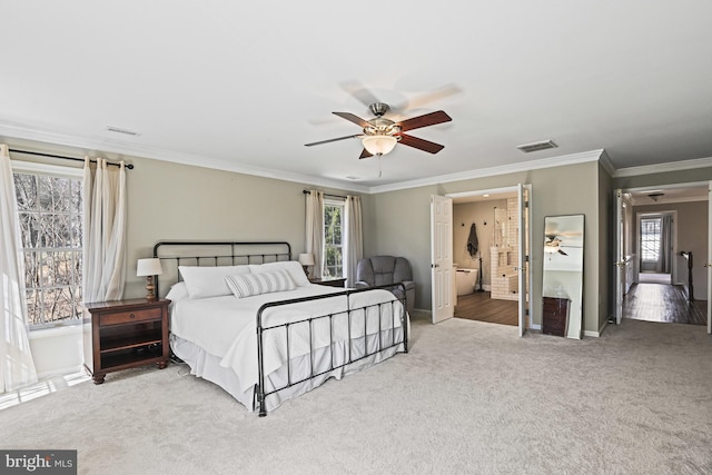 carpeted bedroom featuring visible vents, baseboards, and ornamental molding