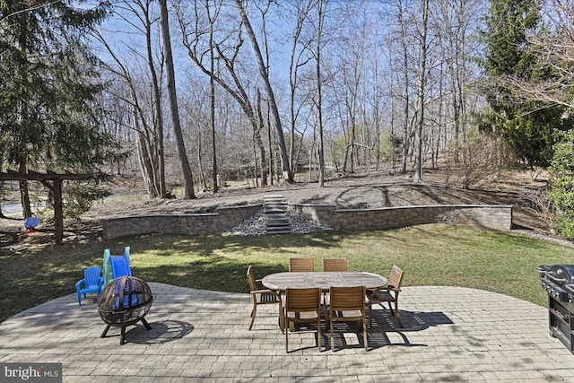 view of patio featuring outdoor dining area and a fire pit