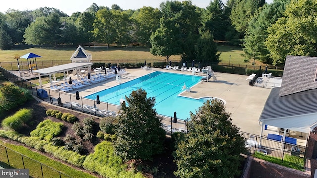 pool featuring a patio area and fence