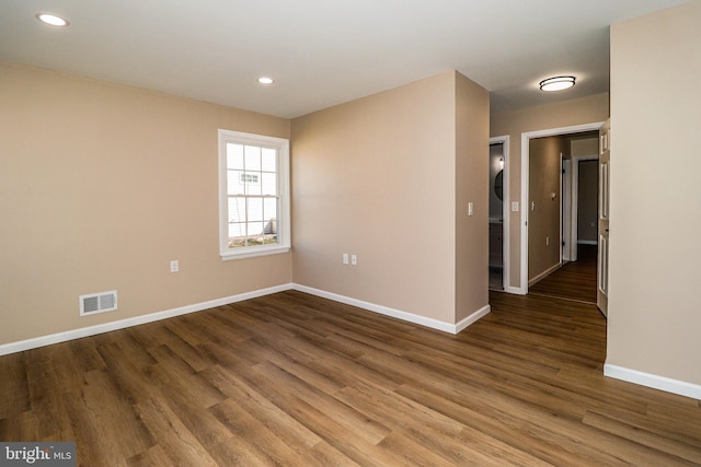 unfurnished room with visible vents, recessed lighting, baseboards, and wood finished floors