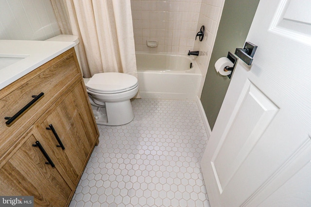 full bath with vanity, tile patterned floors, toilet, and shower / bath combo with shower curtain