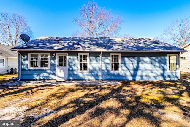 rear view of property featuring central AC