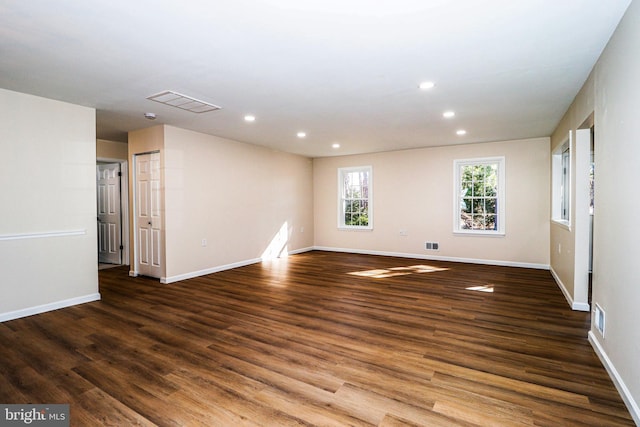 unfurnished room featuring recessed lighting, wood finished floors, and visible vents