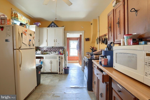 kitchen with a ceiling fan, white cabinetry, white appliances, light countertops, and decorative backsplash