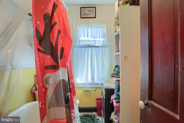 interior space with vanity, plenty of natural light, a shower with curtain, and a bathing tub