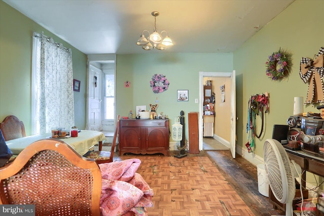 dining space with baseboards and a chandelier